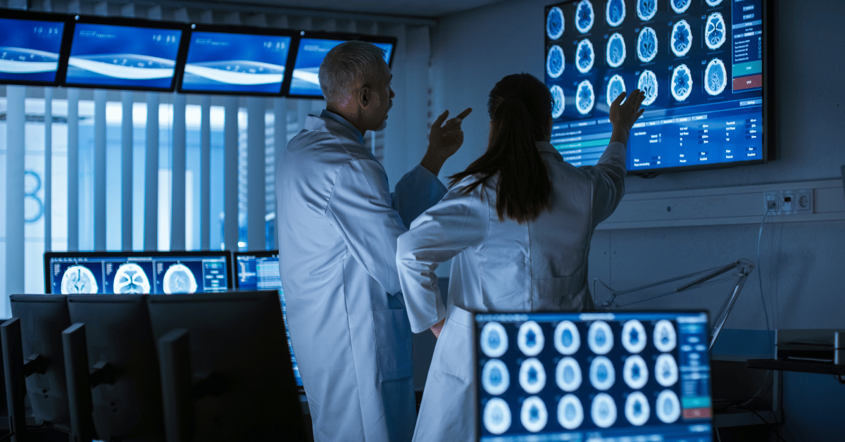 Image of neurophysiologists viewing and discussing results of a brain scan