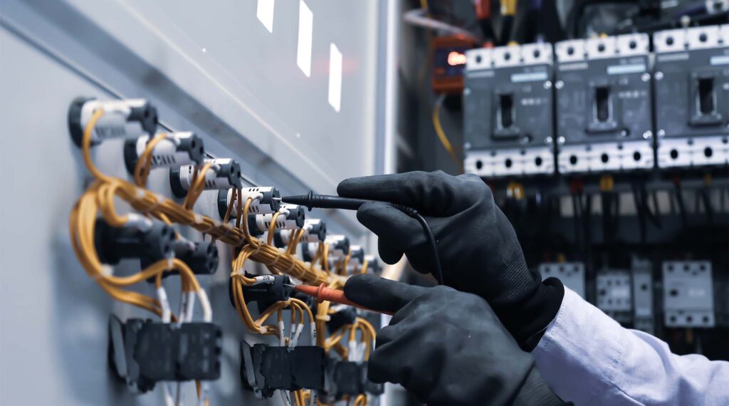 Electrician measuring current with a multimeter