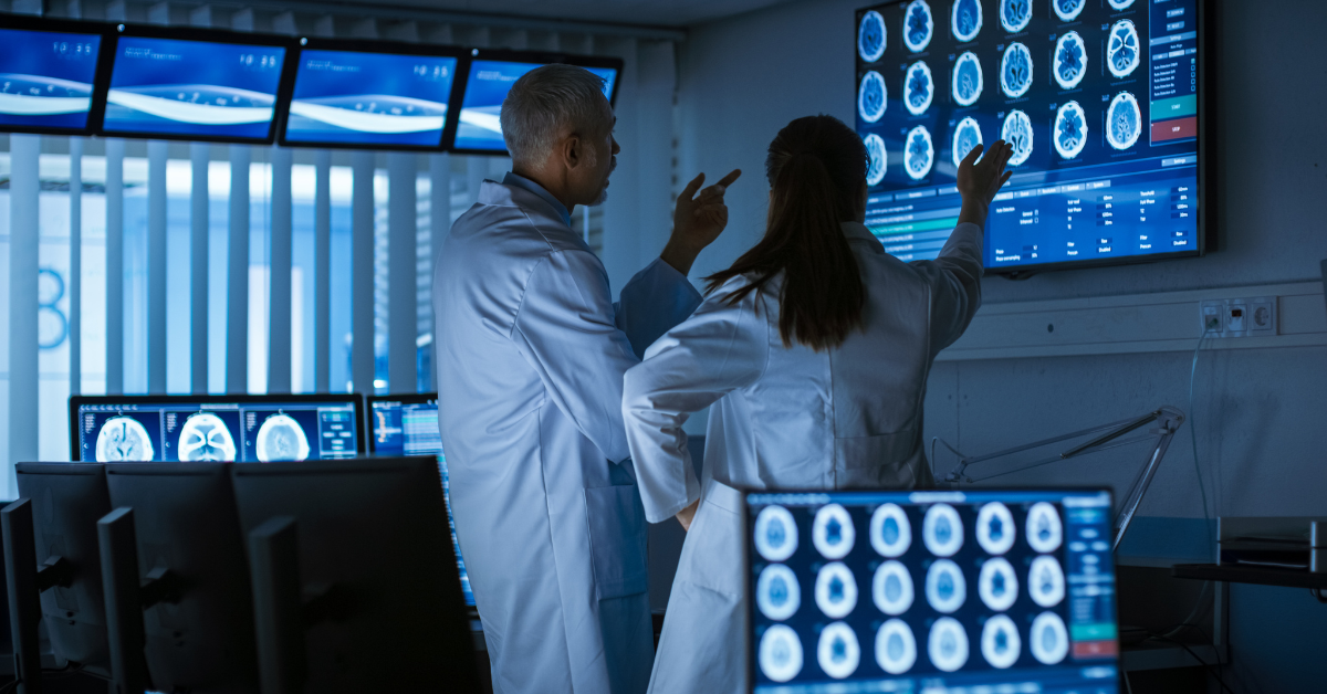 Image of neurophysiologists viewing and discussing results of a brain scan