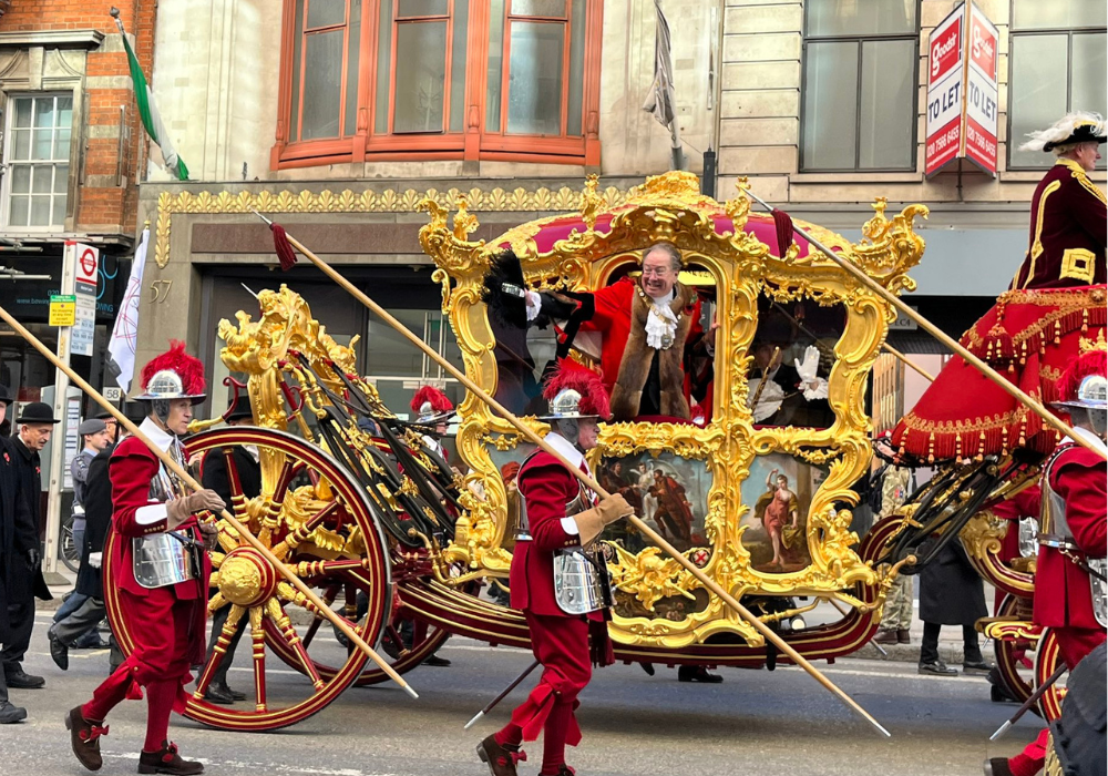 Royal in horse driven cart and escort